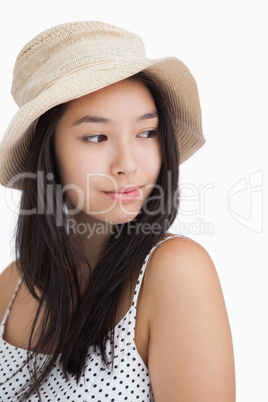 Woman with a straw hat looking away