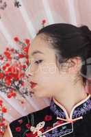 Serene woman wearing traditional Asian clothing