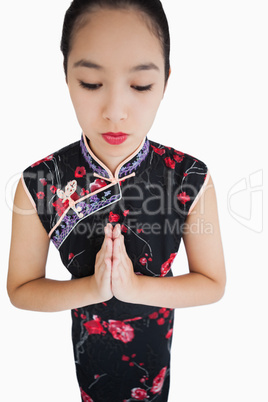 Woman wearing kimono with hands together