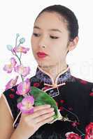 Woman in kimono holding orchid