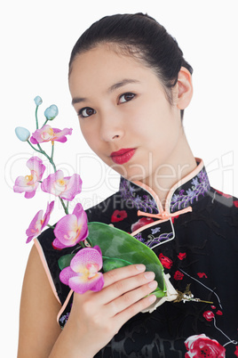 Smiling woman with orchid