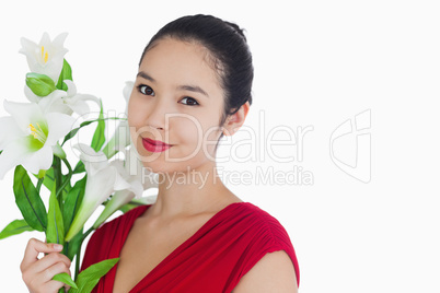 Woman standing while holding flowers