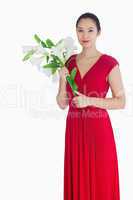 Woman holding lilies in a red dress