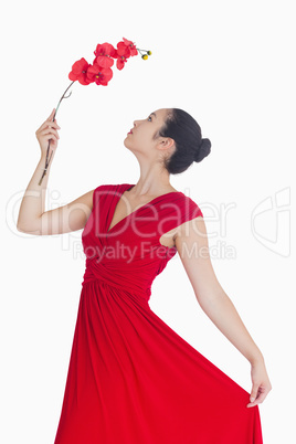 Woman posing with orchid in red dress