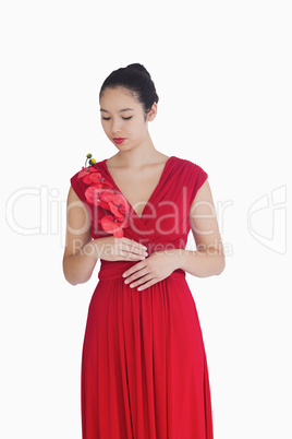Woman in red evening gown holding orchids