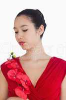 Woman wearing a red dress holding a red orchid