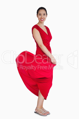 Woman with red dress blowing up
