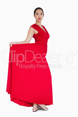 Woman showing the red dress she is wearing