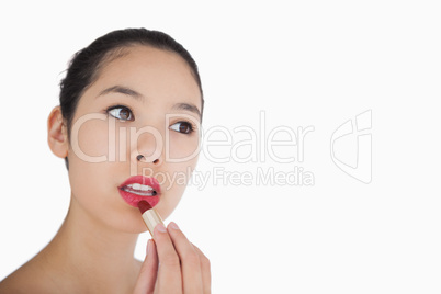 Woman applying lipstick