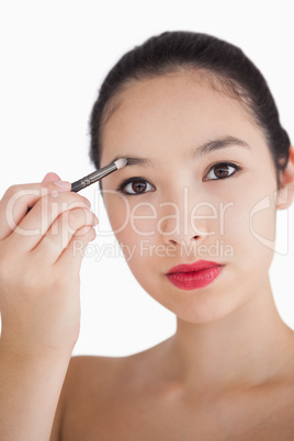 Woman filling in eyebrows