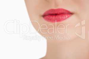 Woman wearing red lipstick against white background