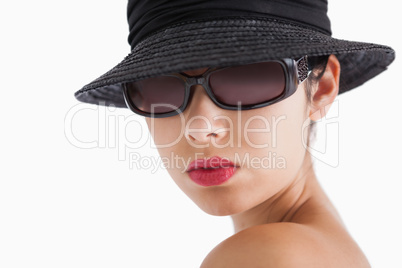Woman wearing sun glasses and hat