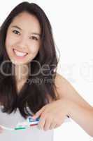 Woman smiling while holding a toothbrush