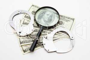 Magnifying glass money and handcuffs