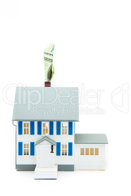 House with money coming out of the chimney