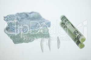 Lines of drugs with rolled up bank note and foil wrap