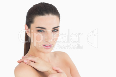 Woman touching her shoulder softly