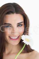 Smiling female beauty holding a flower