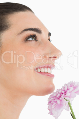Woman holding a flower while smiling