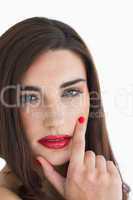 Woman touching her face with red lips