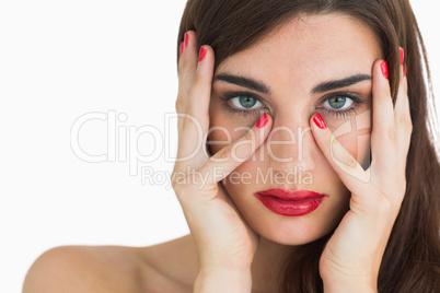 Woman with wavy brown hair wearing the colour red