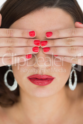 Woman hiding her eyes while wearing red