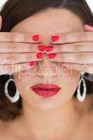Woman hiding her eyes while wearing red