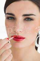Woman colouring her lips
