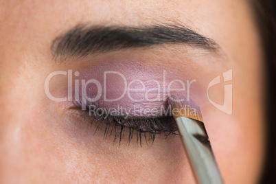 Woman getting eye shadow applied
