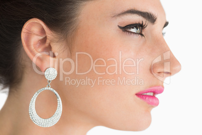 Woman wearing earrings in sixties makeup