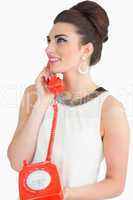 Sixties style woman using dial phone