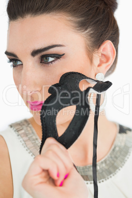 Woman holding a black mask