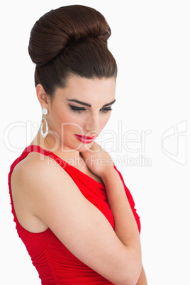Woman holding her shoulder while looking down