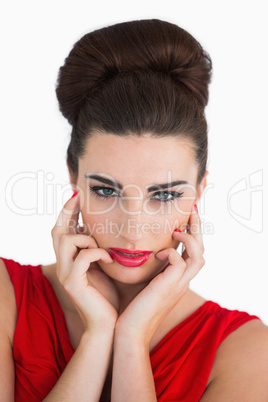 Woman touching her face and looking serious