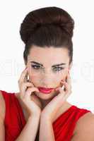Woman touching her face and looking serious