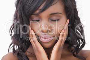 Woman hands in face while eyes closed