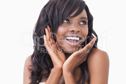 Woman with hands at cheek smiling