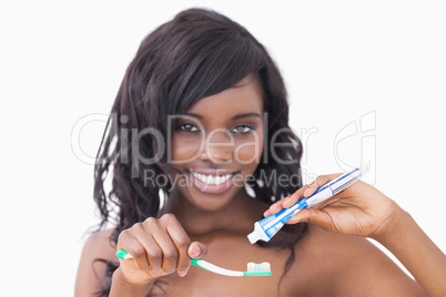 Woman holding a toothbrush and toothpaste