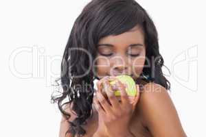Woman holding an apple with eyes closed
