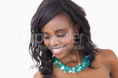 Woman smiling and wearing necklace