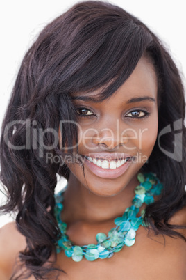 Woman smiling wearing blue necklace