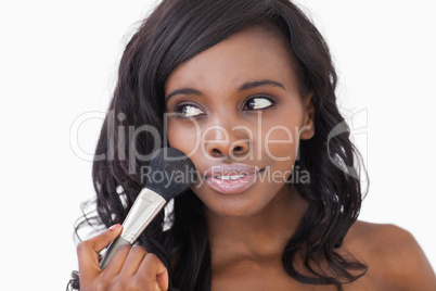 Woman using makeup brush