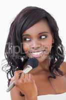Woman holding makeup brush to her face