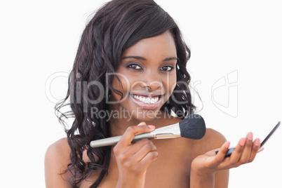 Woman holding powder and a brush