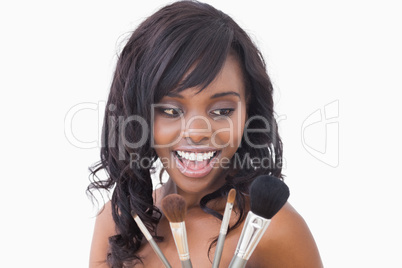 Woman holding makeup brushes