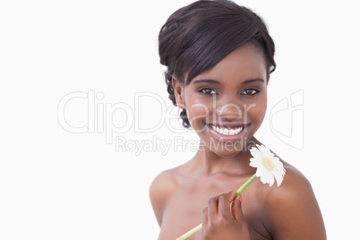Woman smiling holding a flower