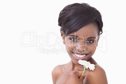 Woman smiling and holding flower