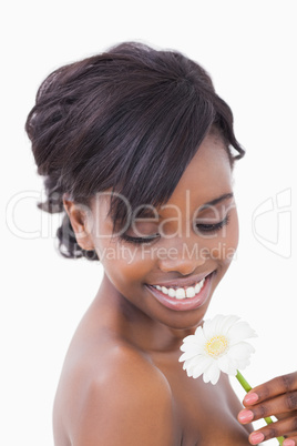 Woman smiling at a flower