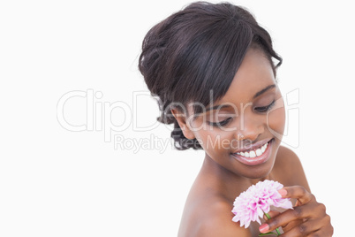 Woman looking at a pink coloured flower