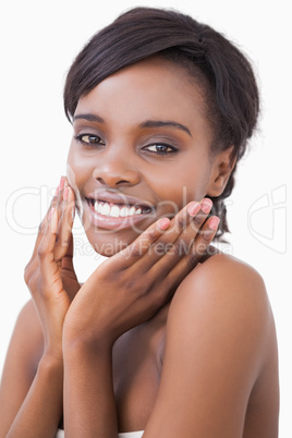 Woman putting on moisturizer